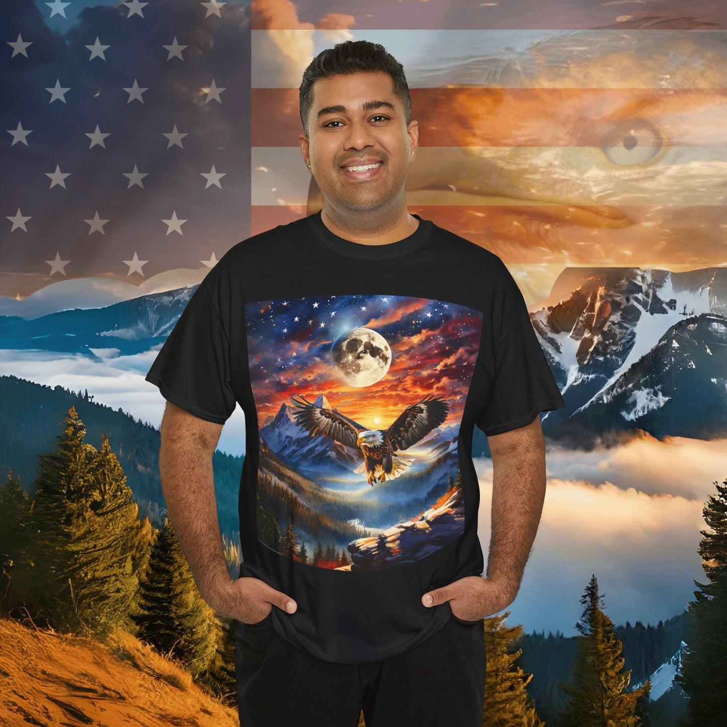 A person stands smiling, wearing a Unisex Heavy Cotton Tee - Stars, Stripes, and Soaring Spirit: A Bald Eagle's Tribute made of sustainably sourced cotton with an eagle graphic. The background features an American flag, a mountainous landscape, and an eagle superimposed on the scene.