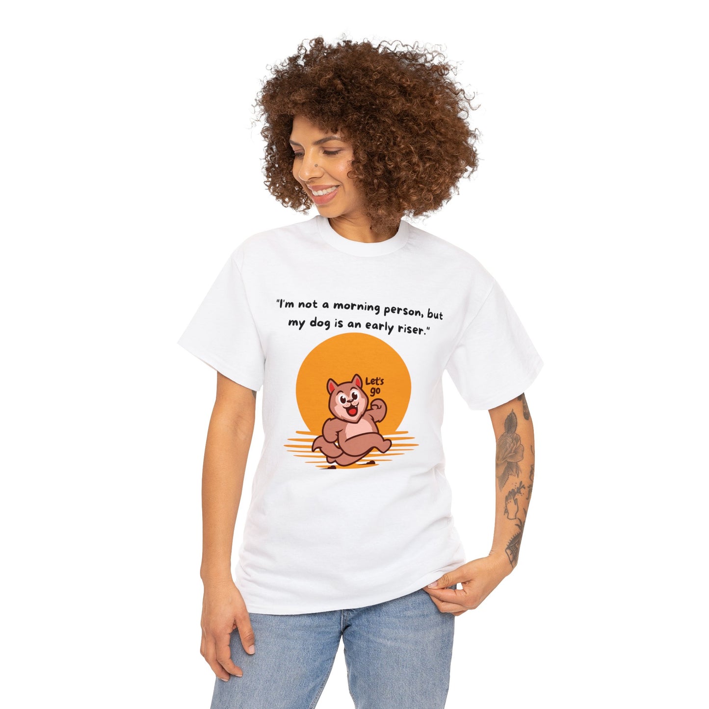 A person is wearing the Unisex Heavy Cotton Tee, a classic fit white T-shirt made of 100% cotton, featuring a cartoon dog and the text "I'm not a morning person; but my dog is an early riser.