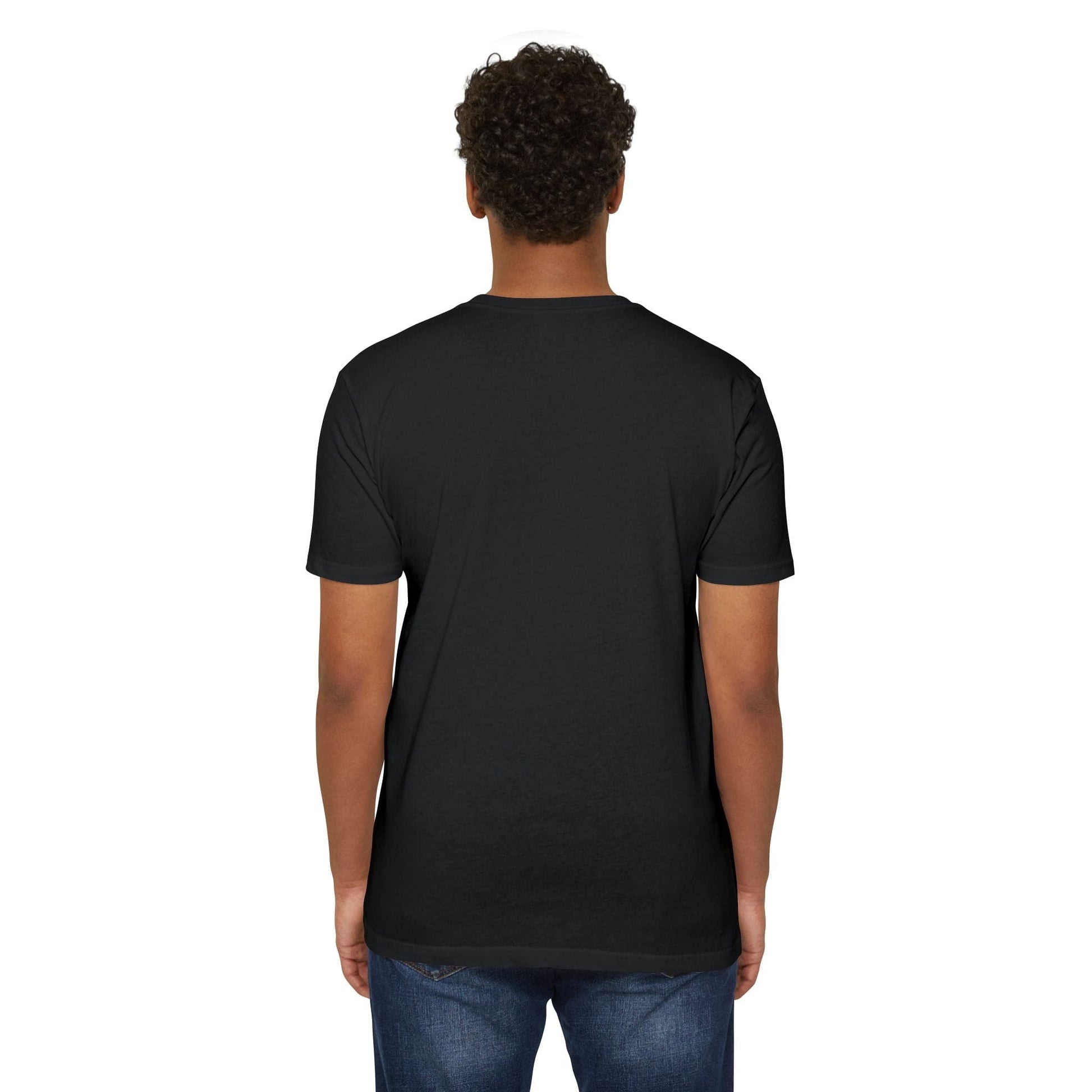 The image shows a person with dark curly hair from the back, wearing blue jeans and a plain black T-shirt featuring the Unicorn Farting Rainbow T-shirt design, standing against a white background.