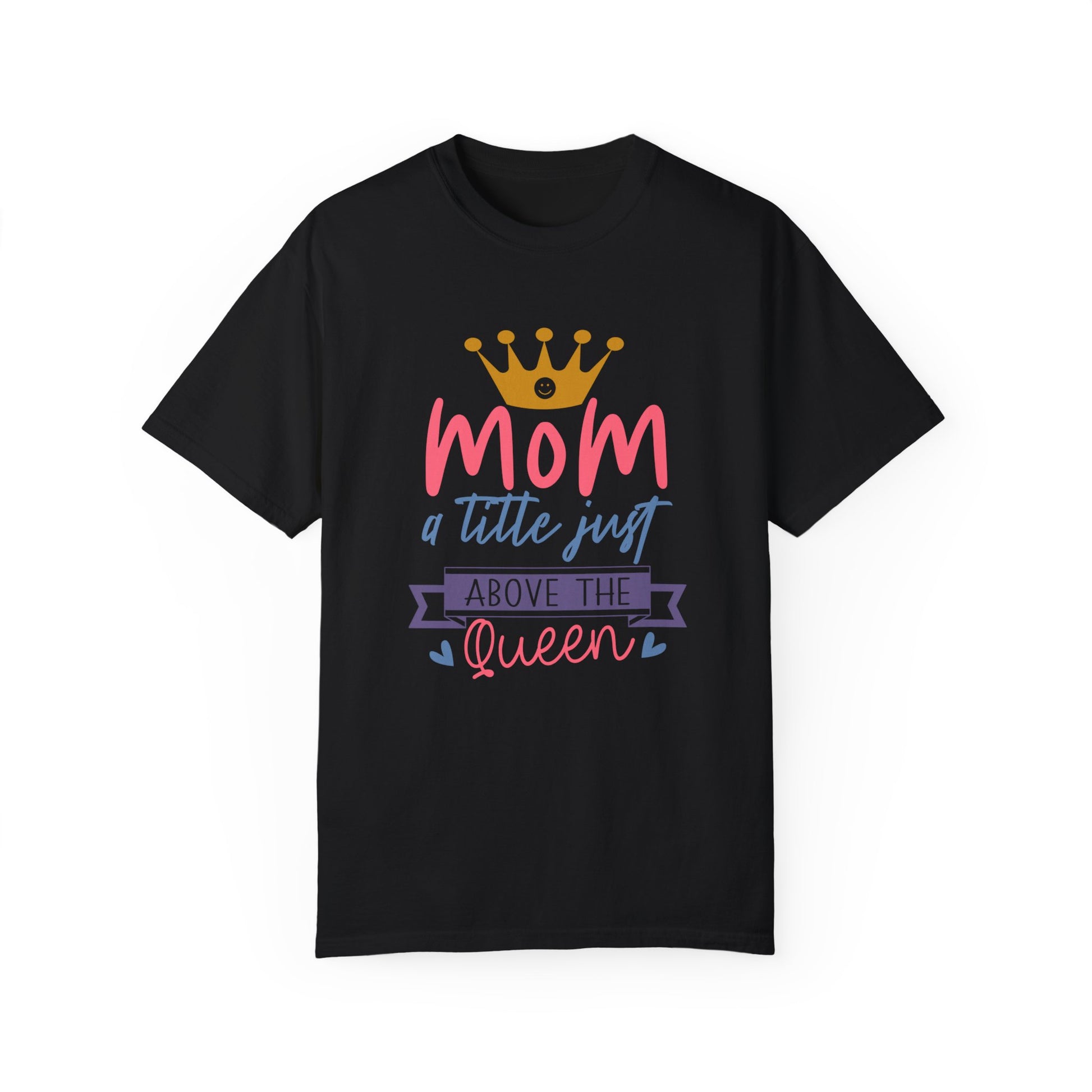 Unisex Comfort Colors 1717 Garment-Dyed T-Shirt in stylish black, designed with soft ring-spun cotton featuring the phrase "Mom, a title just above the Queen" in lively pink, orange, and purple colors. Enhanced with a crown graphic for added charm, this t-shirt provides comfort on par with other Comfort Colors 1717 garment-dyed options.