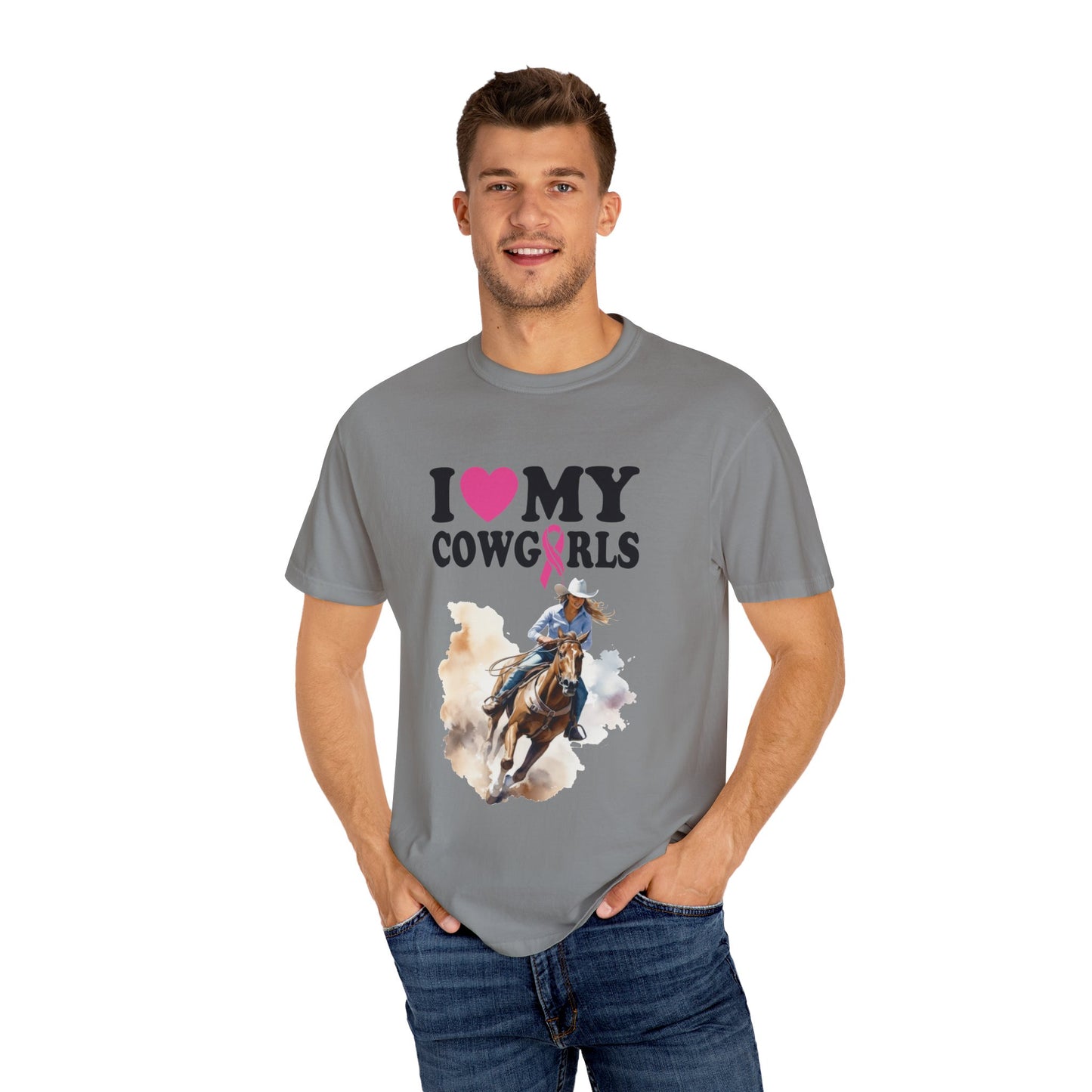 A man with short hair is wearing a gray T-shirt with "I ❤️ MY COWGIRLS" and a graphic of a cowgirl riding a horse on it. The tee, made from 100% ring-spun cotton, boasts the quality and comfort of Stylish Comfort with Unisex Comfort Colors 1717 Garment-Dyed T-Shirt- I LOVE MY COWGIRLS BREAST CANCER AWARENESS.