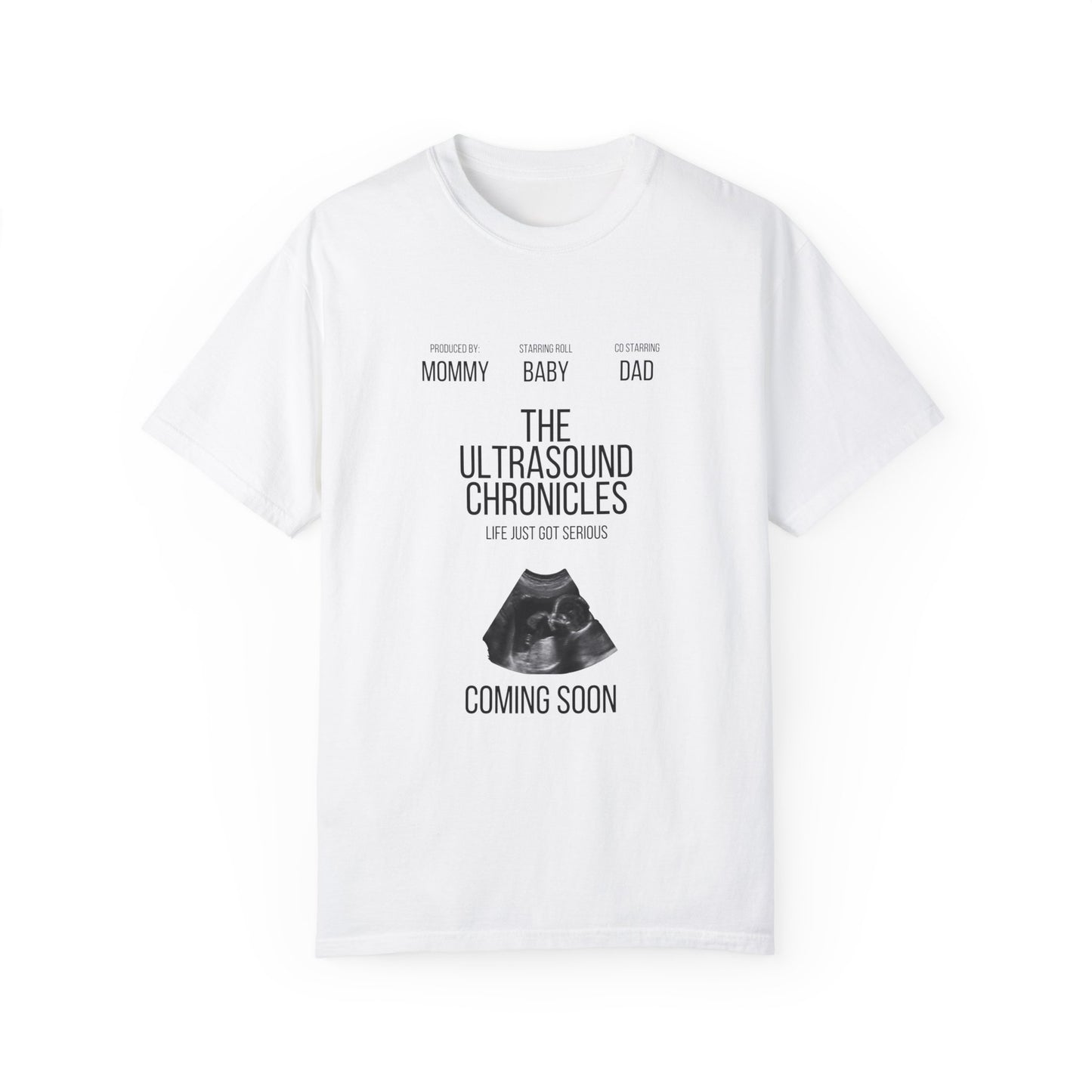 White stylish Unisex Comfort Colors 1717 Garment-Dye- T-shirt with "the ultrasound chronicles" text and an ultrasound image, labeled "new mom, baby, dad," with "coming soon" below.