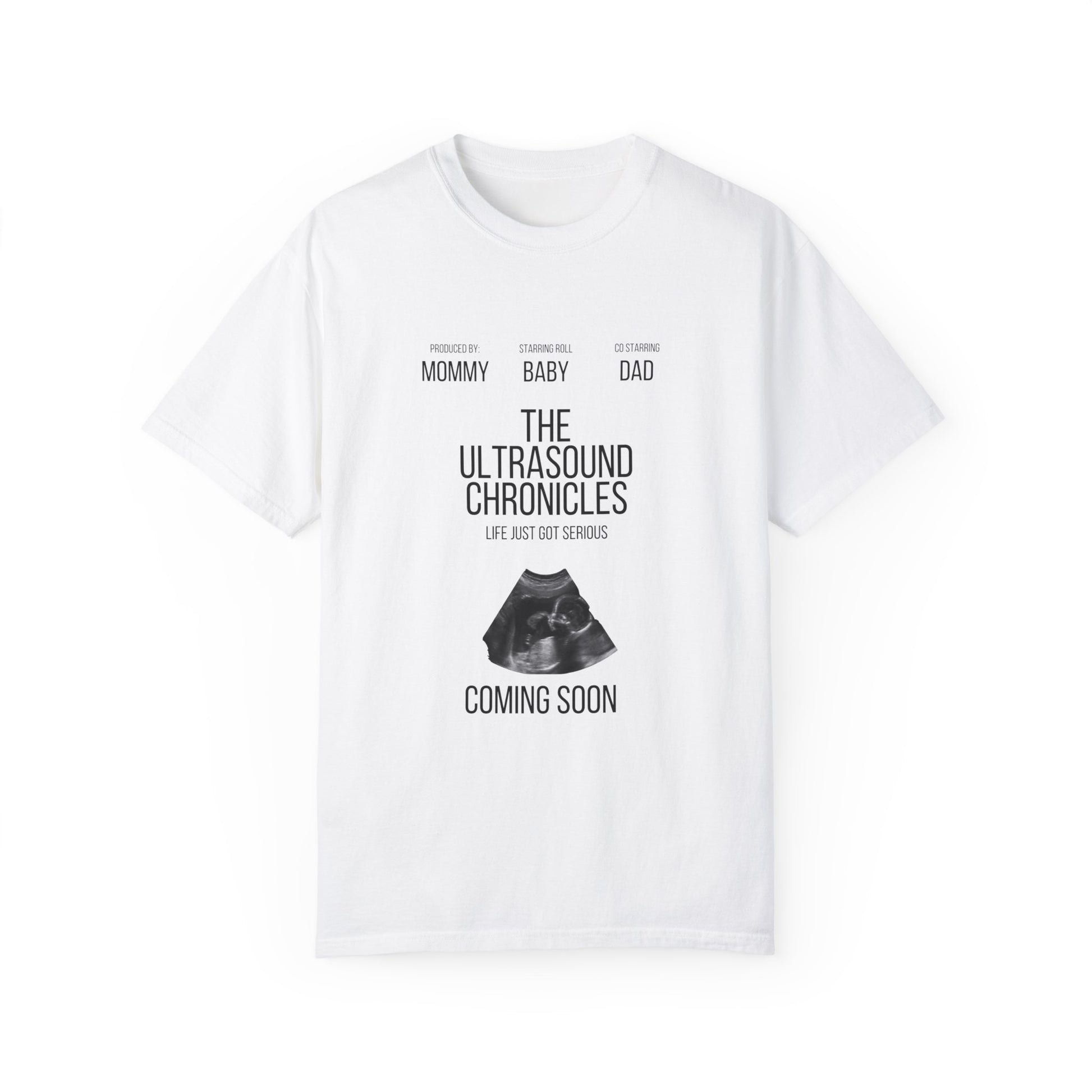 White stylish Unisex Comfort Colors 1717 Garment-Dye- T-shirt with "the ultrasound chronicles" text and an ultrasound image, labeled "new mom, baby, dad," with "coming soon" below.