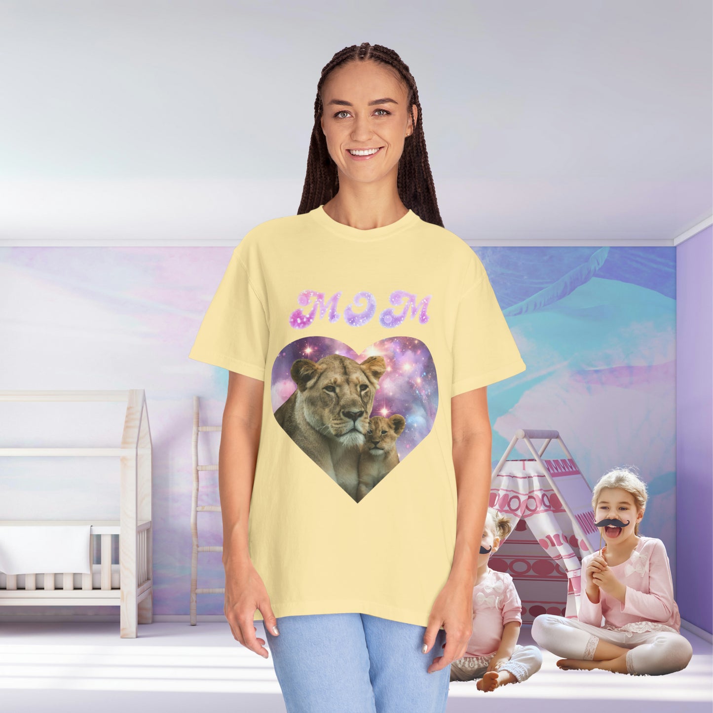 A woman in a yellow Stylish Comfort with Unisex Comfort Colors 1717 Garment-Dye- T-shirt- Heart of the Cosmos: Mom's Lioness Legacy, standing in a room with a child playing in the background.