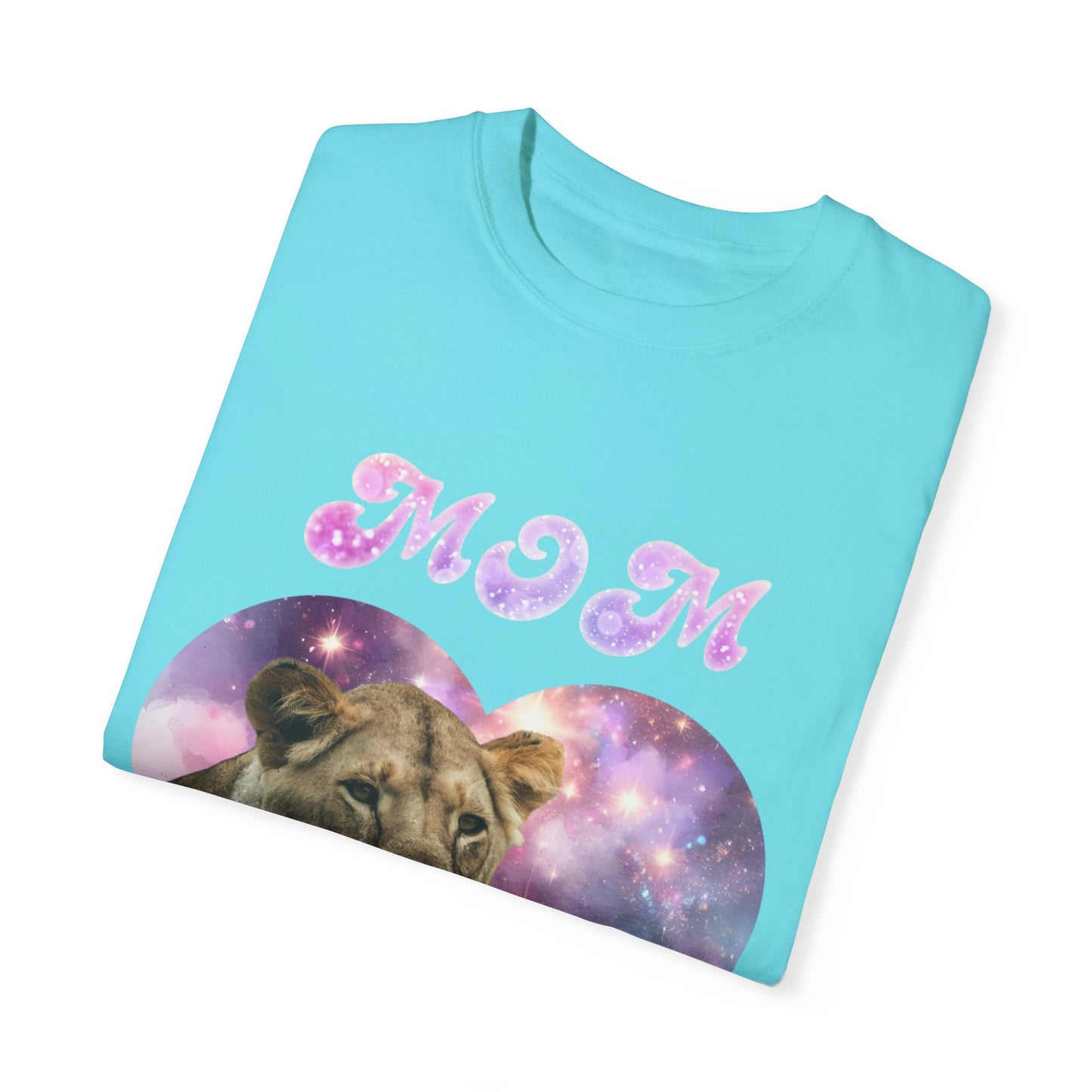 Introducing the Stylish Comfort with the Unisex Comfort Colors 1717 Garment-Dye T-shirt, featuring "Mom" in dazzling pink, purple, and white glittery letters above a lioness nestled within a heart with a cosmic theme. Made from 100% ring-spun cotton, this turquoise tee seamlessly combines comfort and style to celebrate Mom's Lioness Legacy.