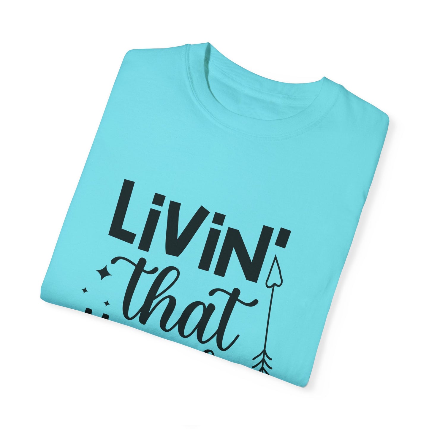 A Stylish Comfort turquoise T-shirt, crafted from soft ring-spun cotton for ultimate comfort, features black text reading "Living that Mom Life" and a small arrow design in garment-dyed fabric.