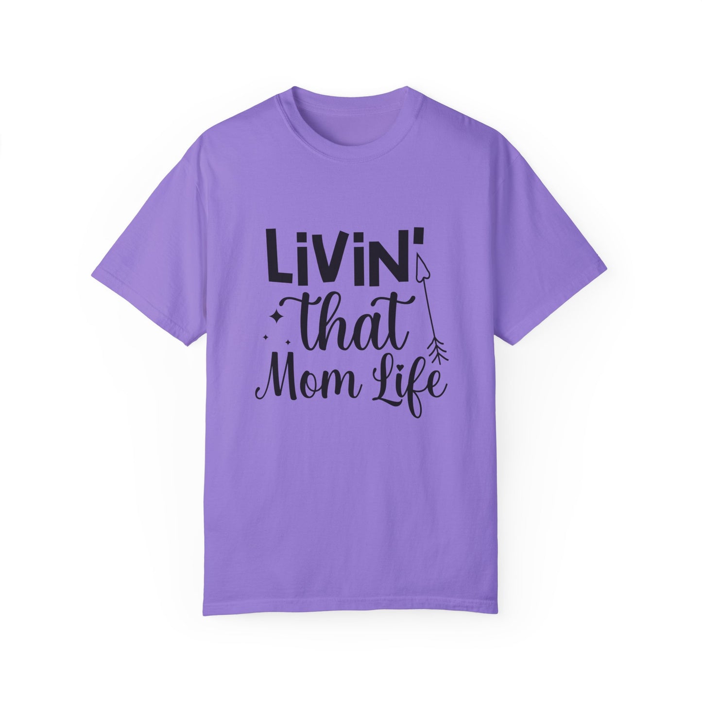 The Stylish Comfort with Unisex Comfort Colors 1717 Garment-Dyed T-Shirt- Living that Mom Life is crafted from soft ring-spun cotton and features "Livin' that Mom Life" in bold black text on a purple tee, offering both comfort and style for your everyday adventures.