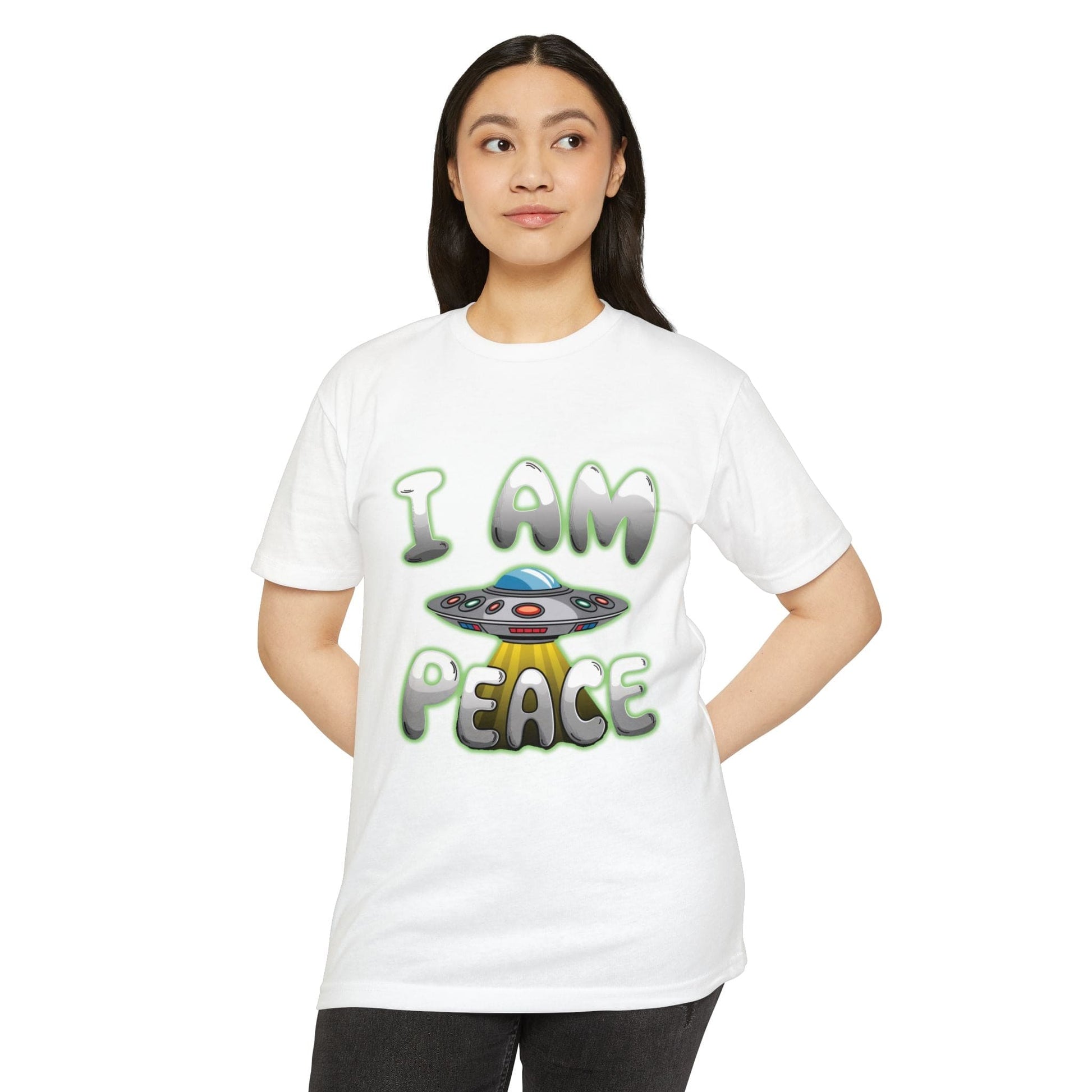 A person wearing a white T-shirt called the "UFO T-shirt I am piece flying saucer," featuring unique designs with the words "I AM PEACE" and a cartoon UFO image on the front.