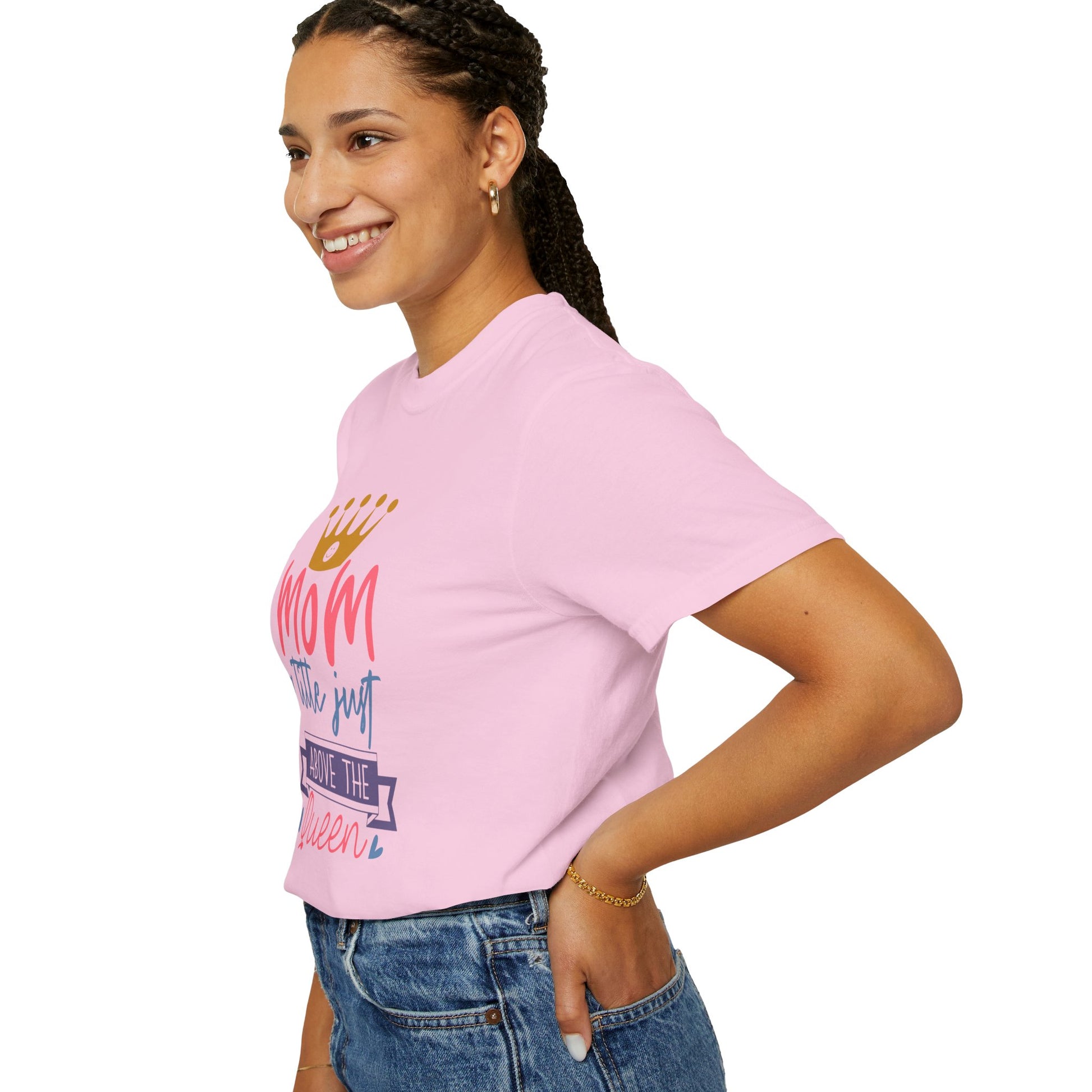 The person wears a vibrant pink "Stylish Comfort with Unisex Comfort Colors 1717 Garment-Dyed T-Shirt - mom just a little above queen," crafted from soft ring-spun cotton, paired with blue jeans. They smile brightly against the plain white background, perfectly capturing the effortless style of this iconic apparel.