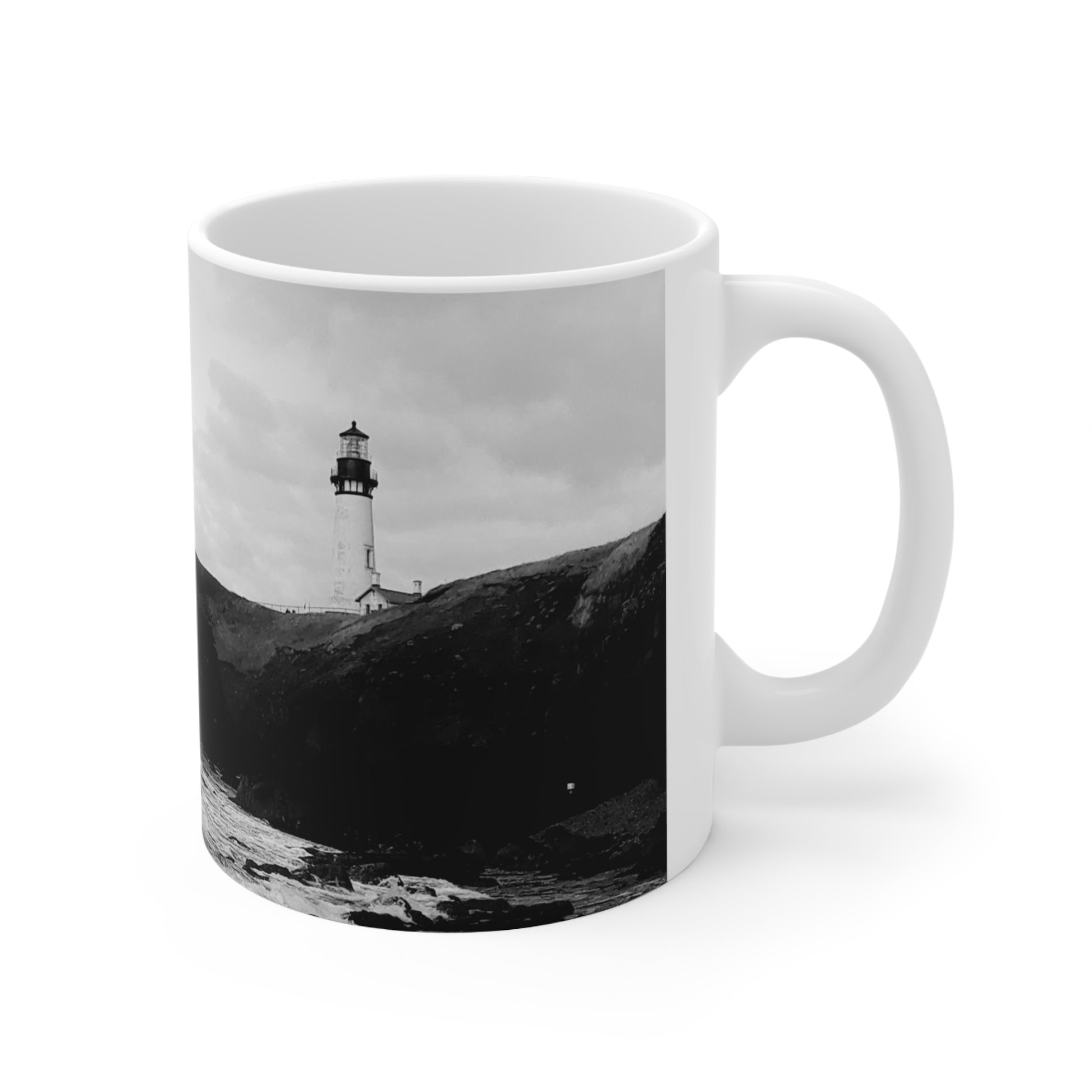 White 11oz ceramic Mug with a black and white photograph of Yaquina head lighthouse in on the oregon coast