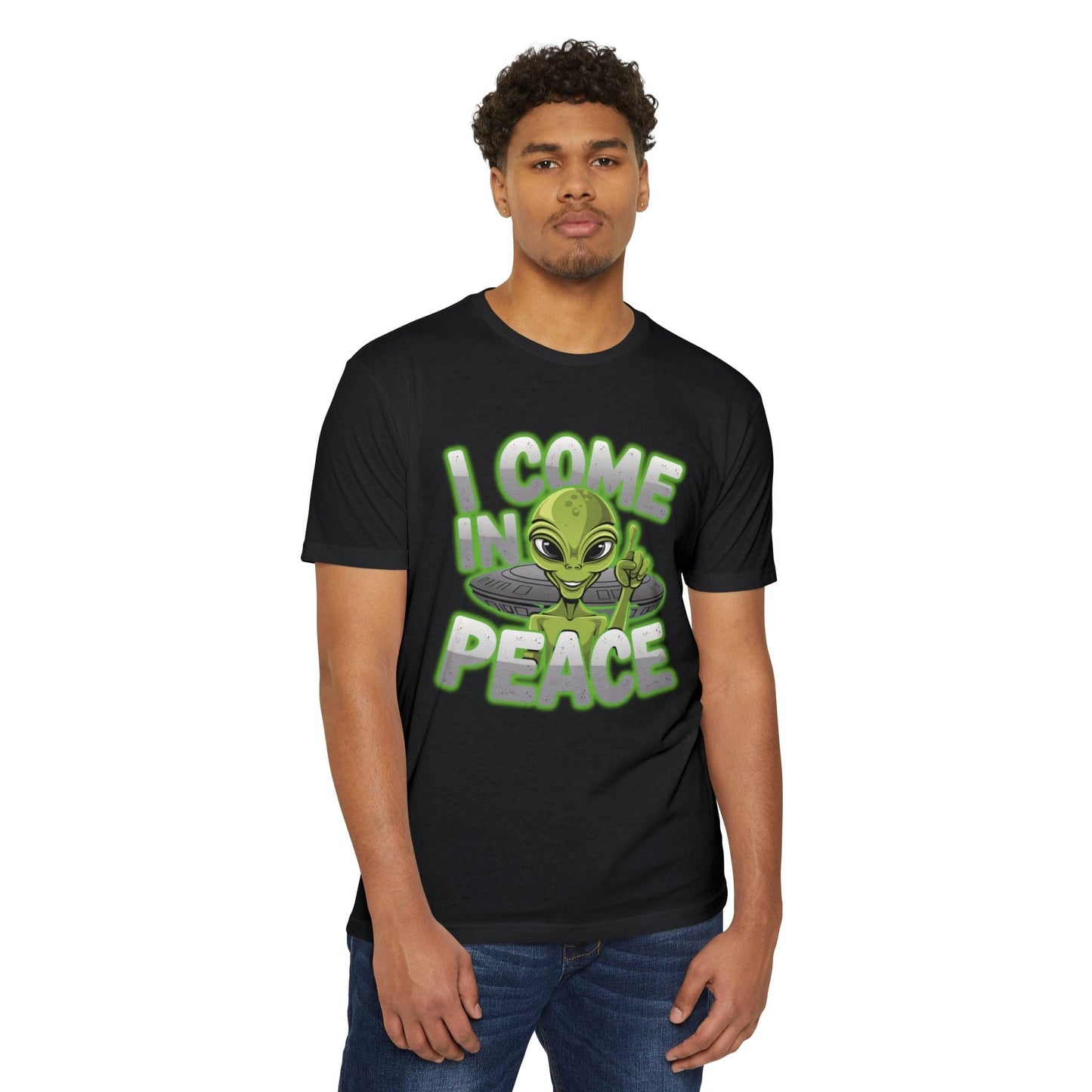 A man wearing the Alien CVC Jersey T-Shirt - I COME IN PEACE, showcasing a sleek black design with an alien graphic and the words "I COME IN PEACE"—ideal casual wear for sci-fi enthusiasts.