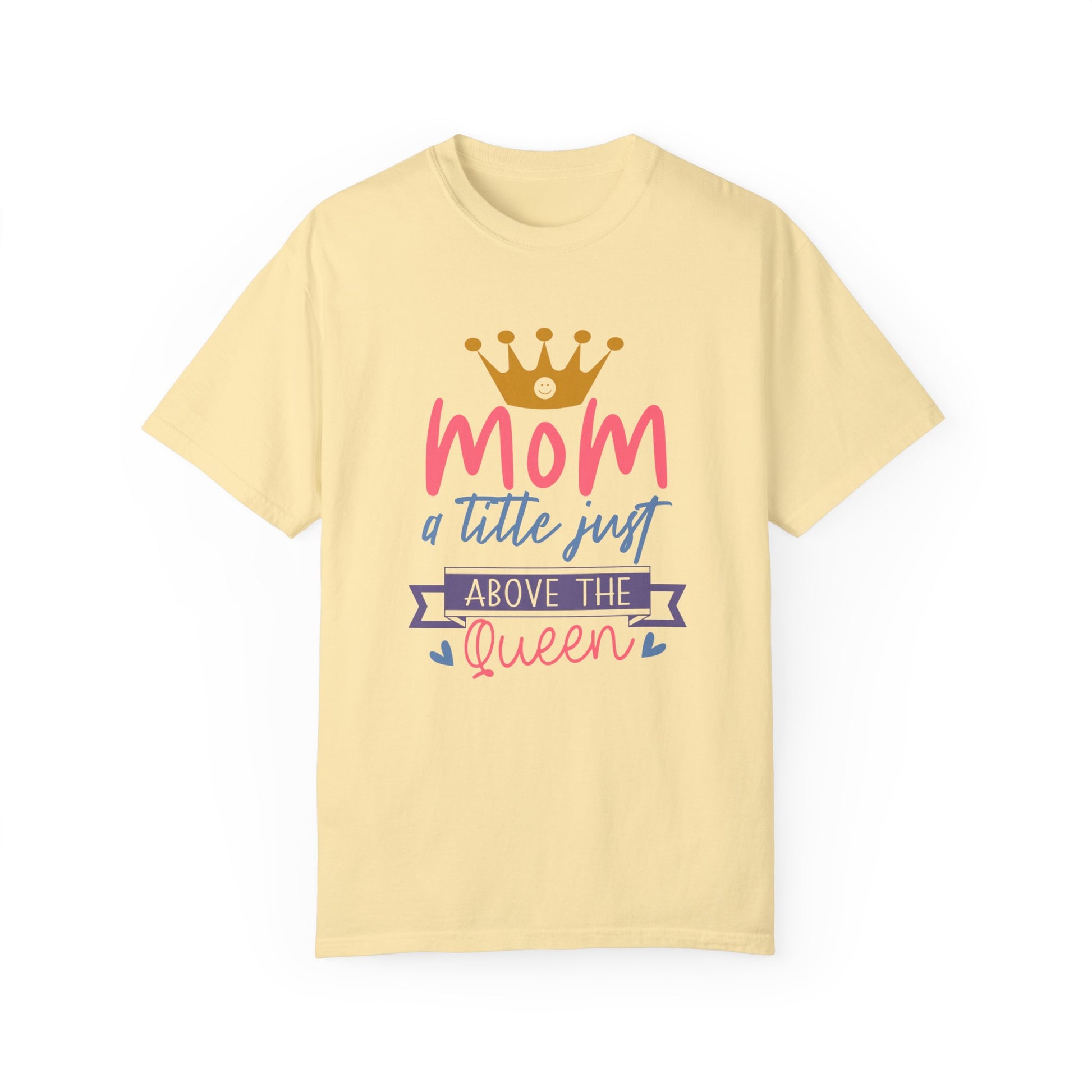 This yellow unisex T-shirt, crafted from ring-spun cotton and featuring a crown design with the vibrant purple, pink, and blue text "Mom, just a little above the queen," offers stylish comfort similar to Comfort Colors 1717 garment-dyed T-shirts.