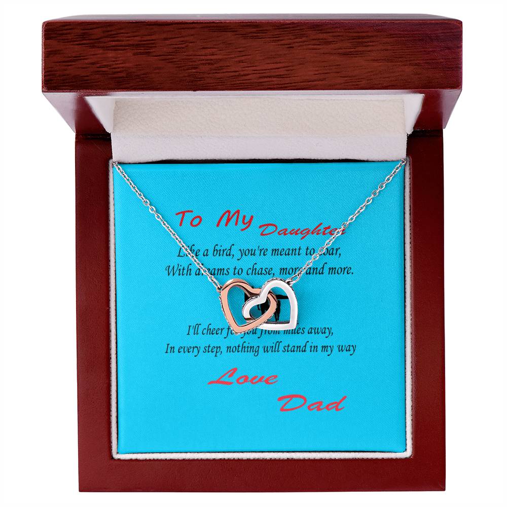 A Interlocking Hearts Necklace- Father Daughter Like a Bird displayed in an open wooden box. The box has a sentimental message addressed to a daughter from Dad, making it a beautiful gift for Father’s Day.