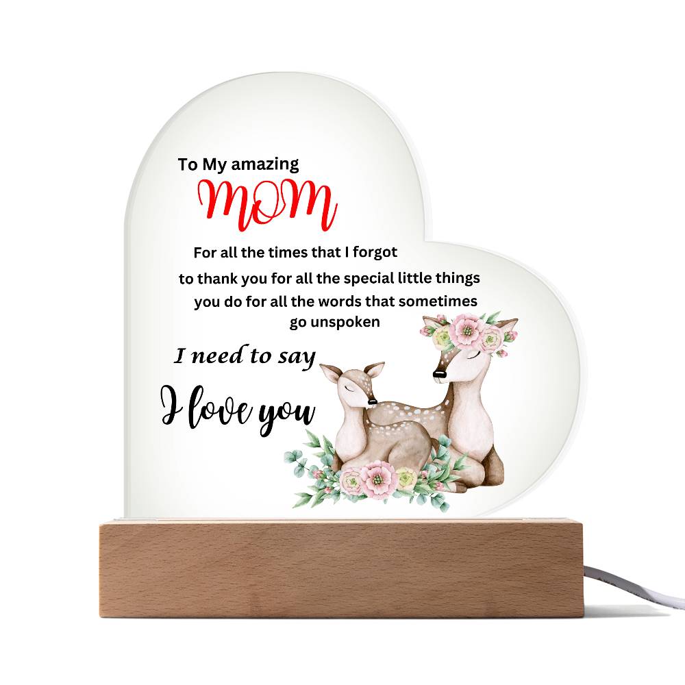 An To my amazing mom i need to say i love you deer acrylic heart plaque with wooden base adorned with a deer and flower, symbolizing love.