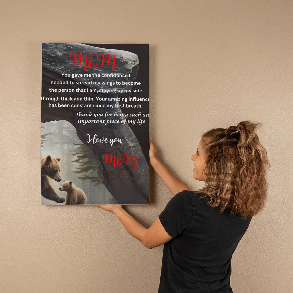 A woman holding up a gallery wrapped canvas with a "Mom You Gave Me the Confidence Bear" and a poem on it, created using high-pigmented ink.