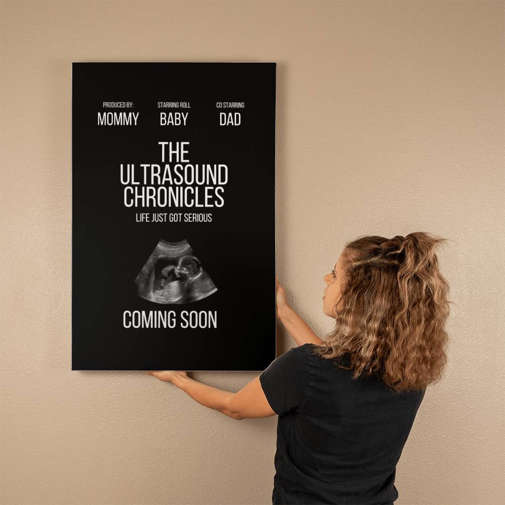 A new mom hangs a Gallery Wrapped Canvas (2:3) titled "The Ultrasound Chronicles," featuring an ultrasound image, on a wall.