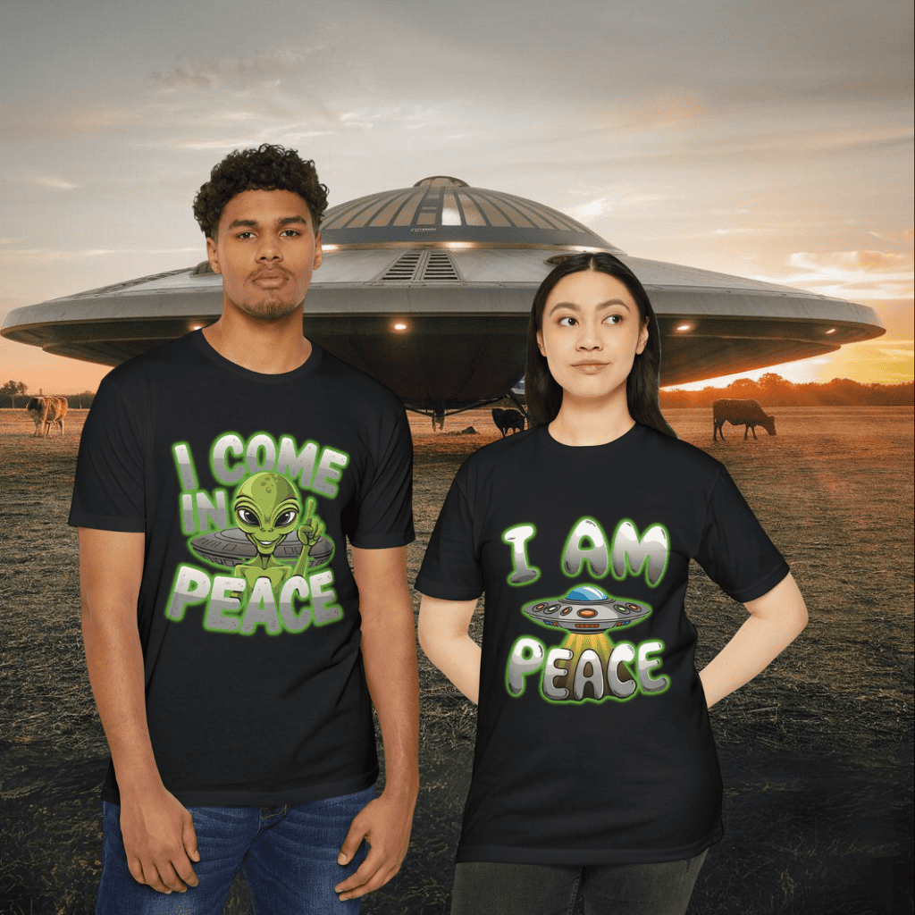 A man and woman, both sci-fi enthusiasts dressed in casual outfits, stand outside before a spacecraft. He sports an "Alien CVC Jersey T-shirt - I COME IN PEACE," while her shirt reads "I AM PEACE." In the background, cows graze peacefully as the sun sets.